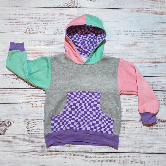 The fabulous purple trippy checked Mama's hoodie. Handmade using purple trippy checked cotton jersey, mint, pink and grey cotton French terry and purple cotton ribbing. With a warped checked front pocket.