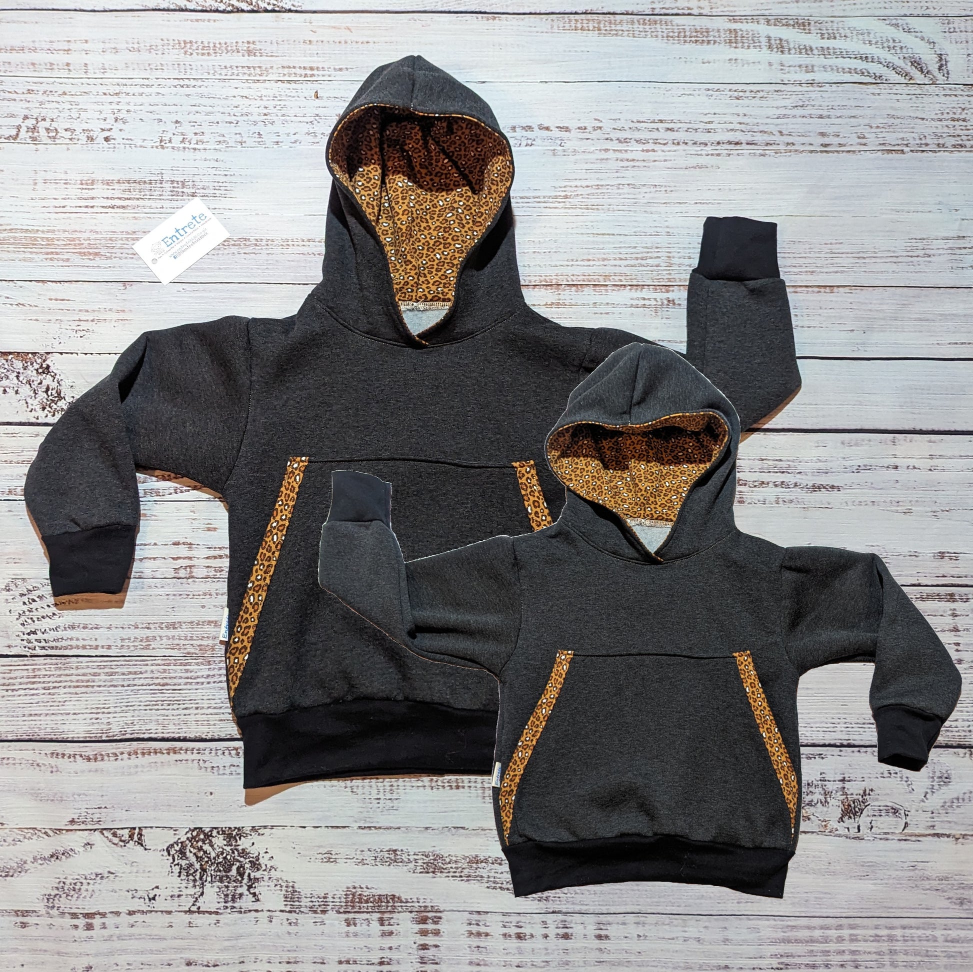 Gorgeous camel leopard print Mama and mini hoodie set. Handmade using charcoal French Terry and cotton ribbing, with camel leopard print cotton jersey hood lining and pocket edging.