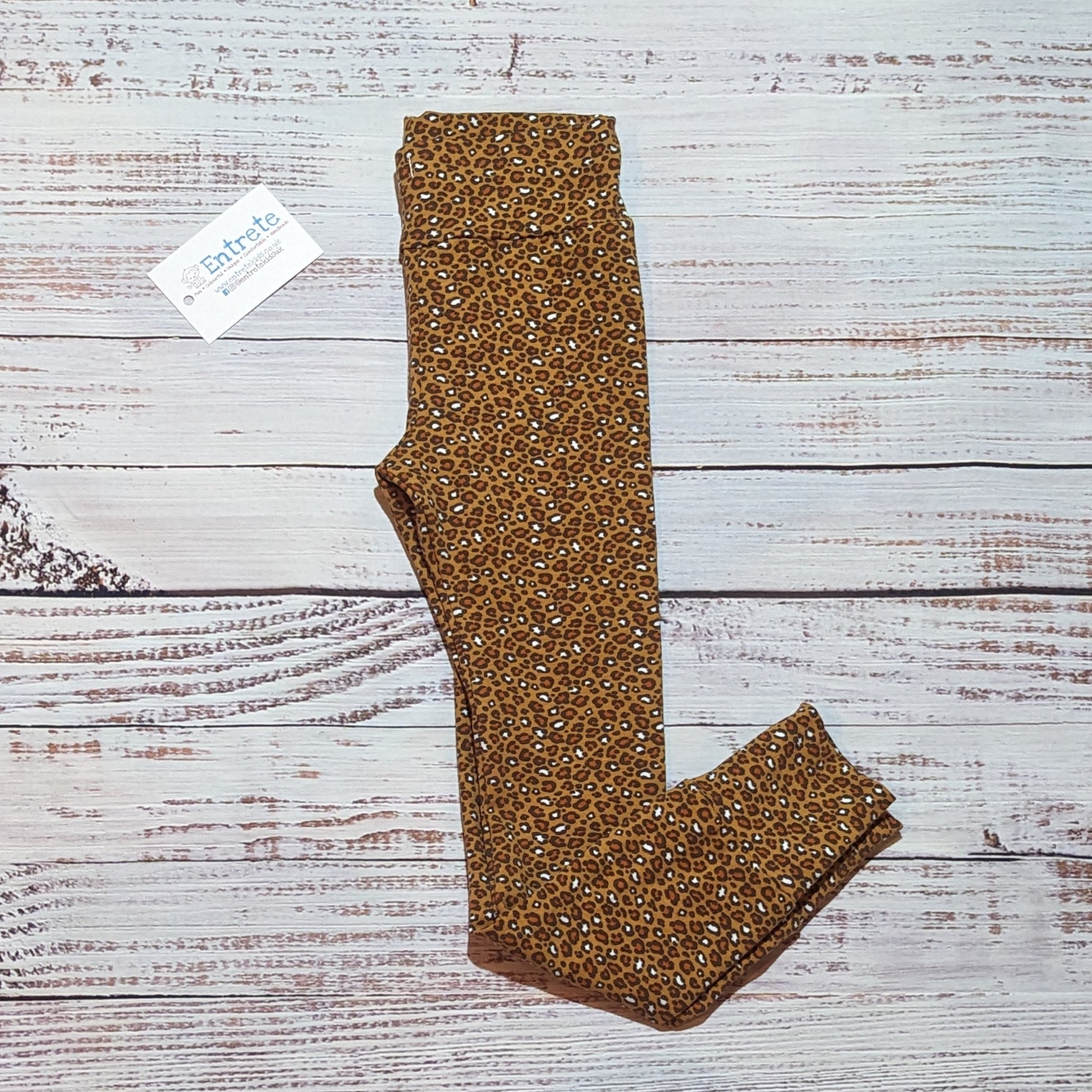 Soft, stretchy camel leopard print kids leggings. Handmade from cotton jersey. Shown folded.