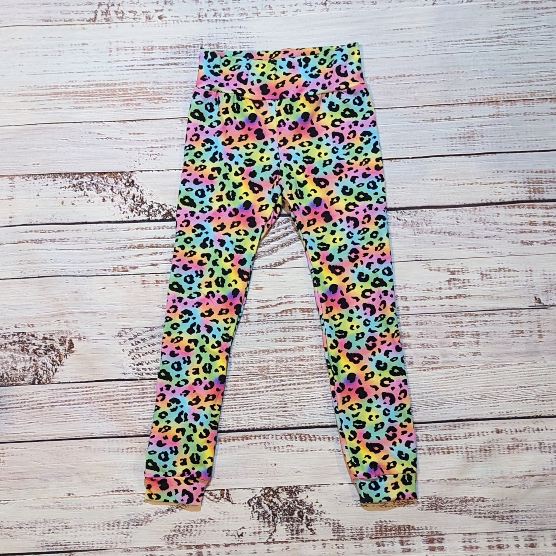 Ladies colourful animal print leggings. Lovingly handmade using soft and stretchy rainbow leopard print cotton jersey.