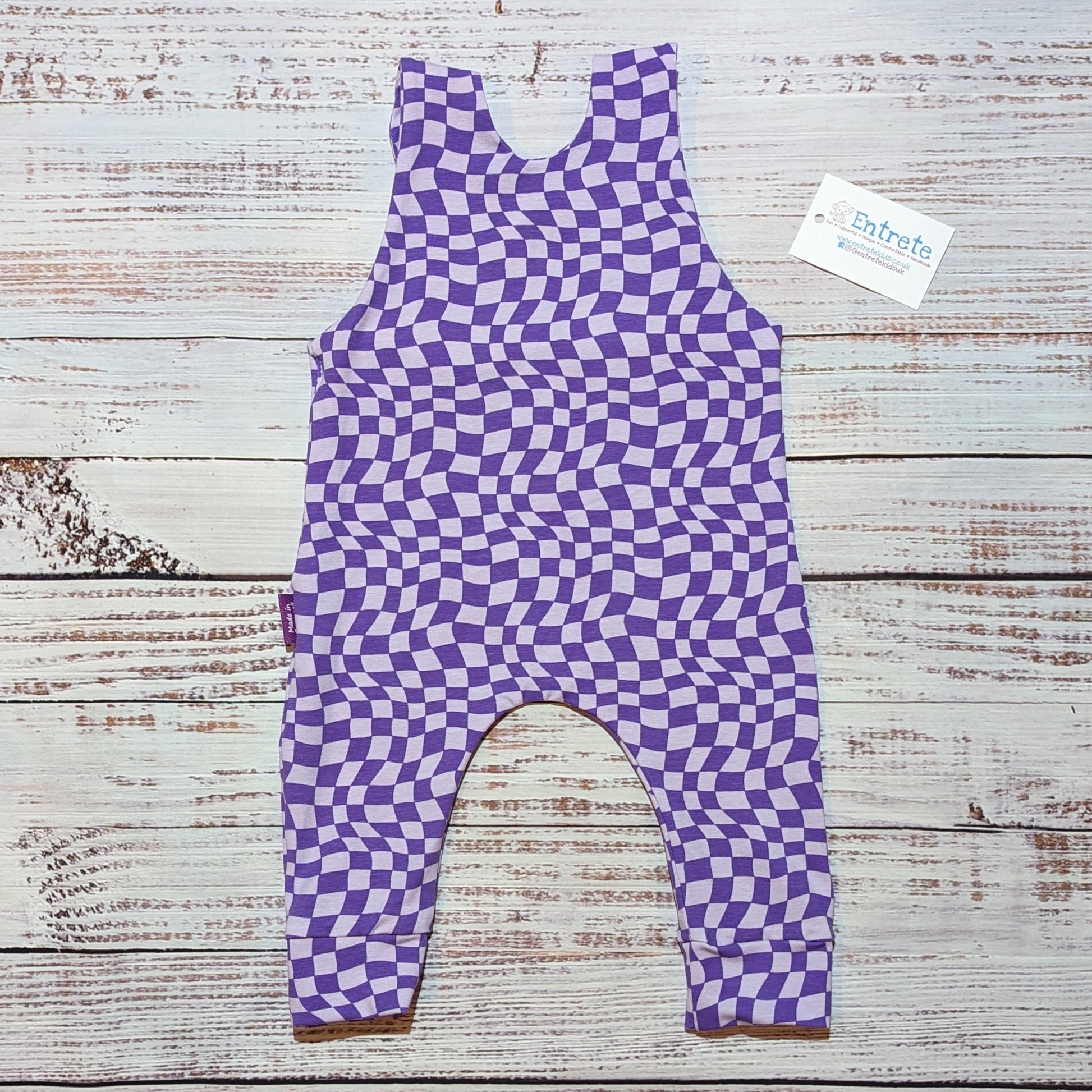 Warped purple checked sleeveless romper. Handmade in soft, stretchy and comfortable cotton jersey. Shown from the rear.