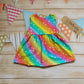 Front of Girls & Babies back popper dress, handmade in bright rainbow stars cotton jersey. Shown in the sleeveless version.