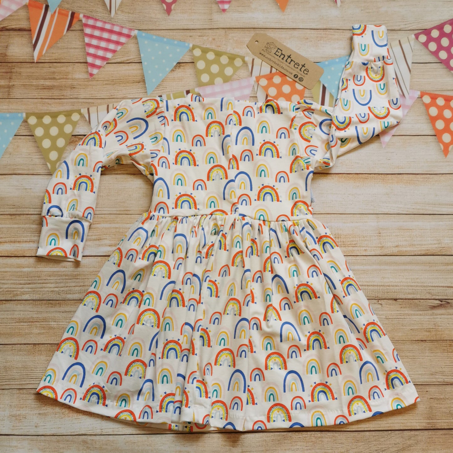 Rear of Girls & toddlers back popper dress, handmade using the fun white colourful rainbows and hearts cotton jersey.