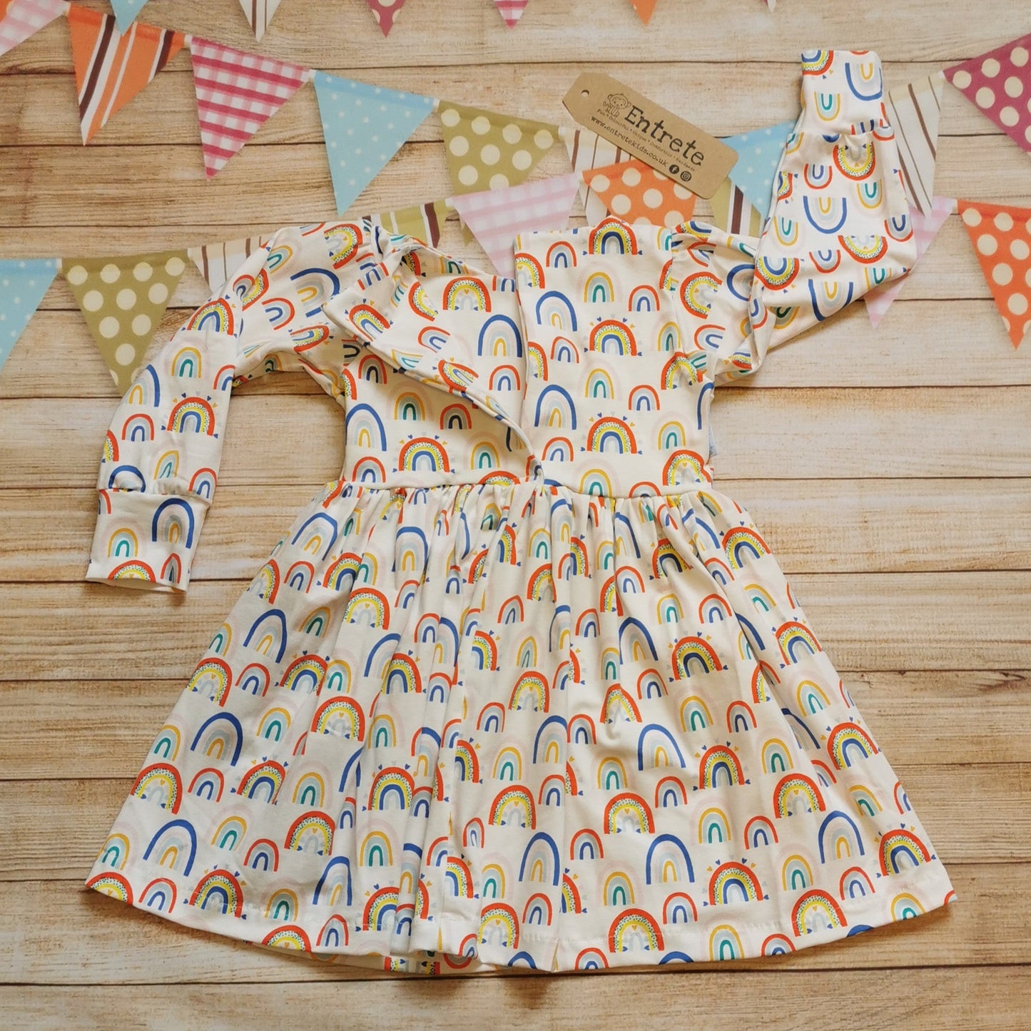 Girls & toddlers back popper dress, handmade using the fun white colourful rainbows and hearts cotton jersey. Showing waist up popper entry, found on sizes 9-12 months and over.