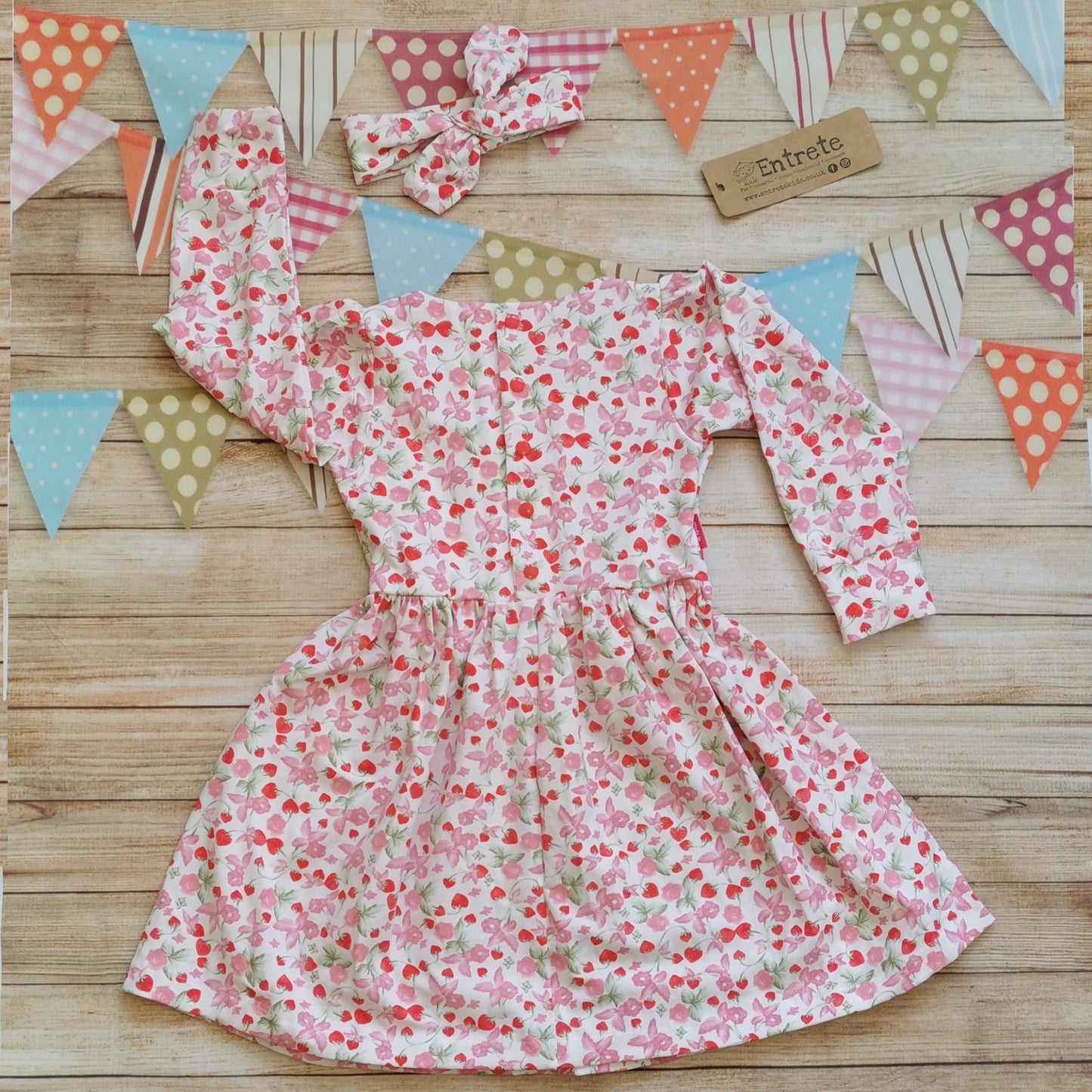 Fresh smelling girls fragranced dress. Handmade with fragranced strawberries and cream cotton jersey. Shown with a matching headband (sold separately) Rear view with popper opening for sizes over 9-12 months, smaller sizes get poppers the full length of the dress.