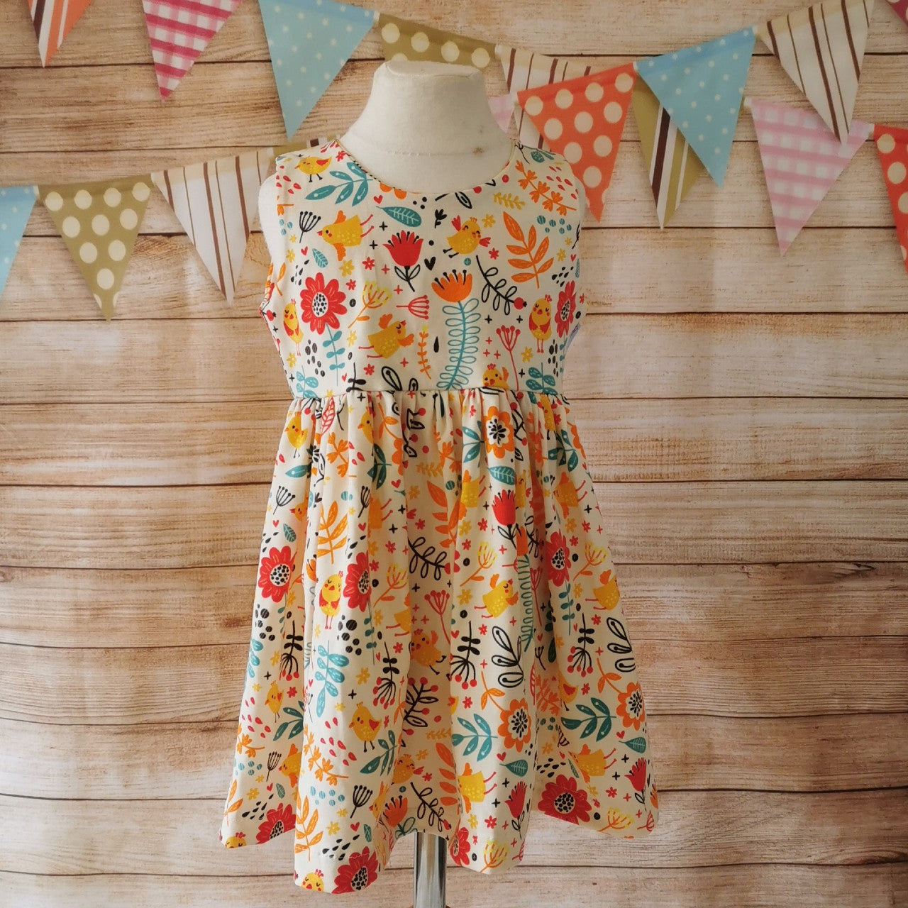 Front of Girls Sleeveless Back Popper Dress, handmade using the fun cream chicks cotton jersey.