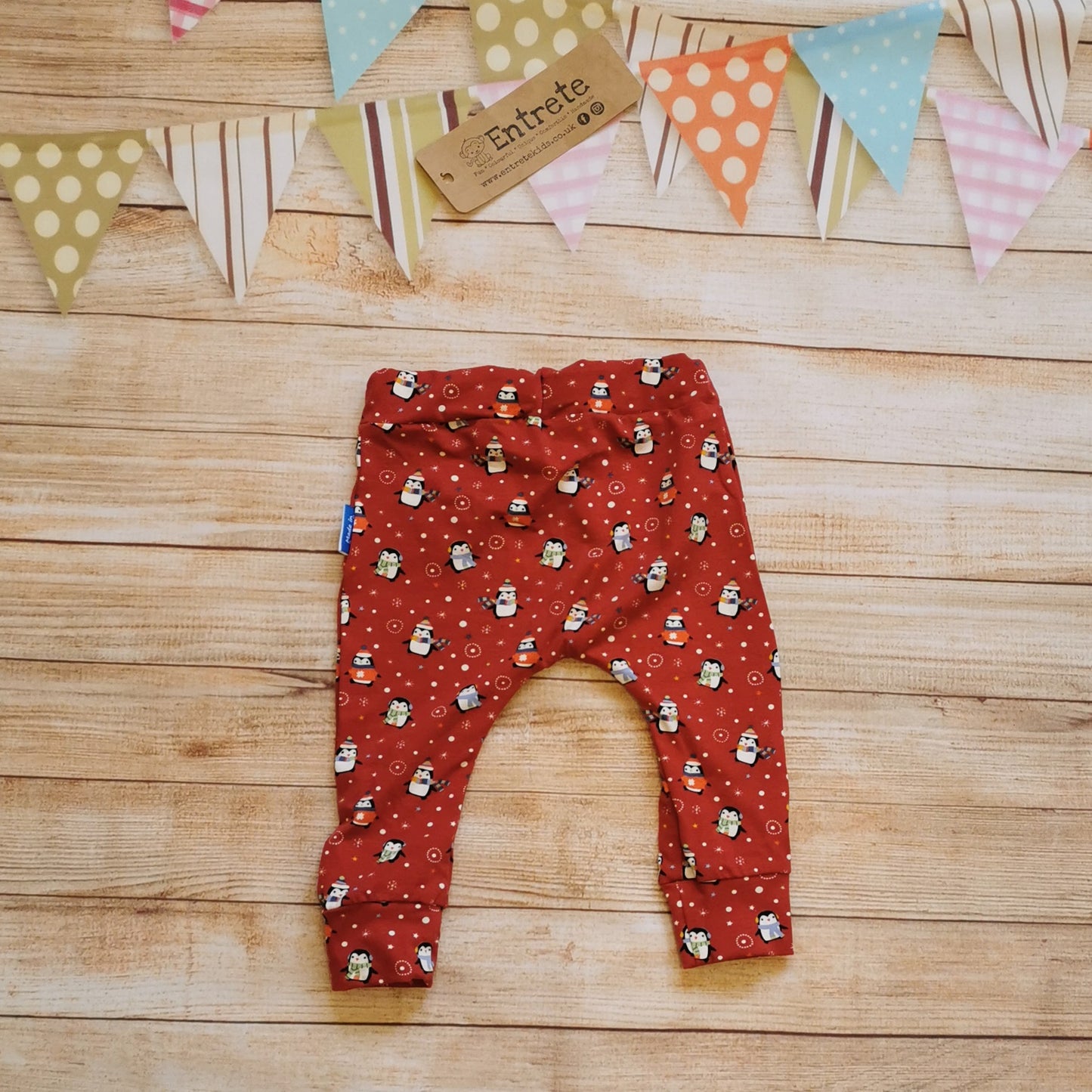 Rear view of the fun and festive harem joggers handmade using red penguins cotton jersey.