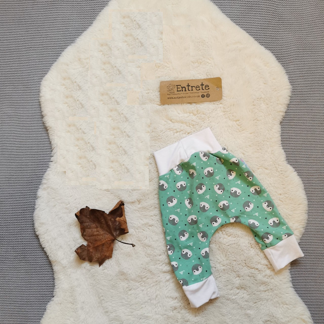 Rear view of  soft, comfortable harem pants with a non-elasticated waistband perfect for younger children. Handmade using the adorable mint penguins organic cotton jersey and white organic cotton jersey.