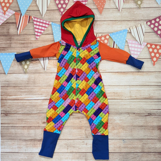 The unique, colourful building blocks hooded romper. Handmade using colourful building blocks, royal blue, red, yellow and orange cotton jersey's with green cotton ribbing.