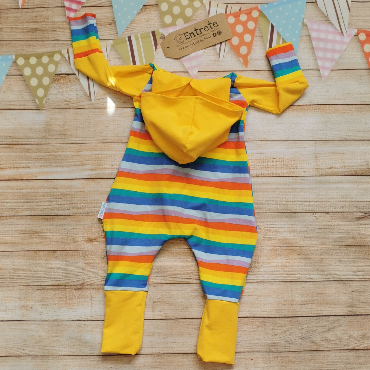 Back of Unisex kids hooded popper romper, handmade with red rainbow striped cotton jersey body and cuffs, organic yellow cotton jersey hood, arms and lower legs.