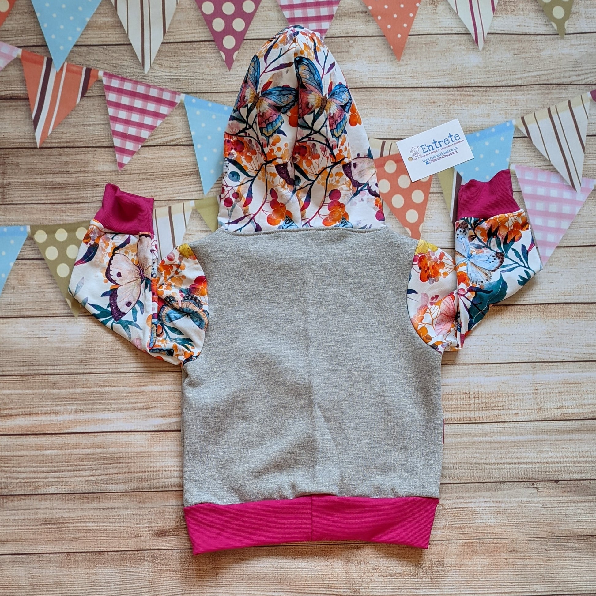 The gorgeous vibrant butterflies hoodie, handmade using fuchsia cotton jersey and cotton ribbing, grey cotton sweatshirt fleece and vibrant butterflies cotton French terry. Shown from the rear.