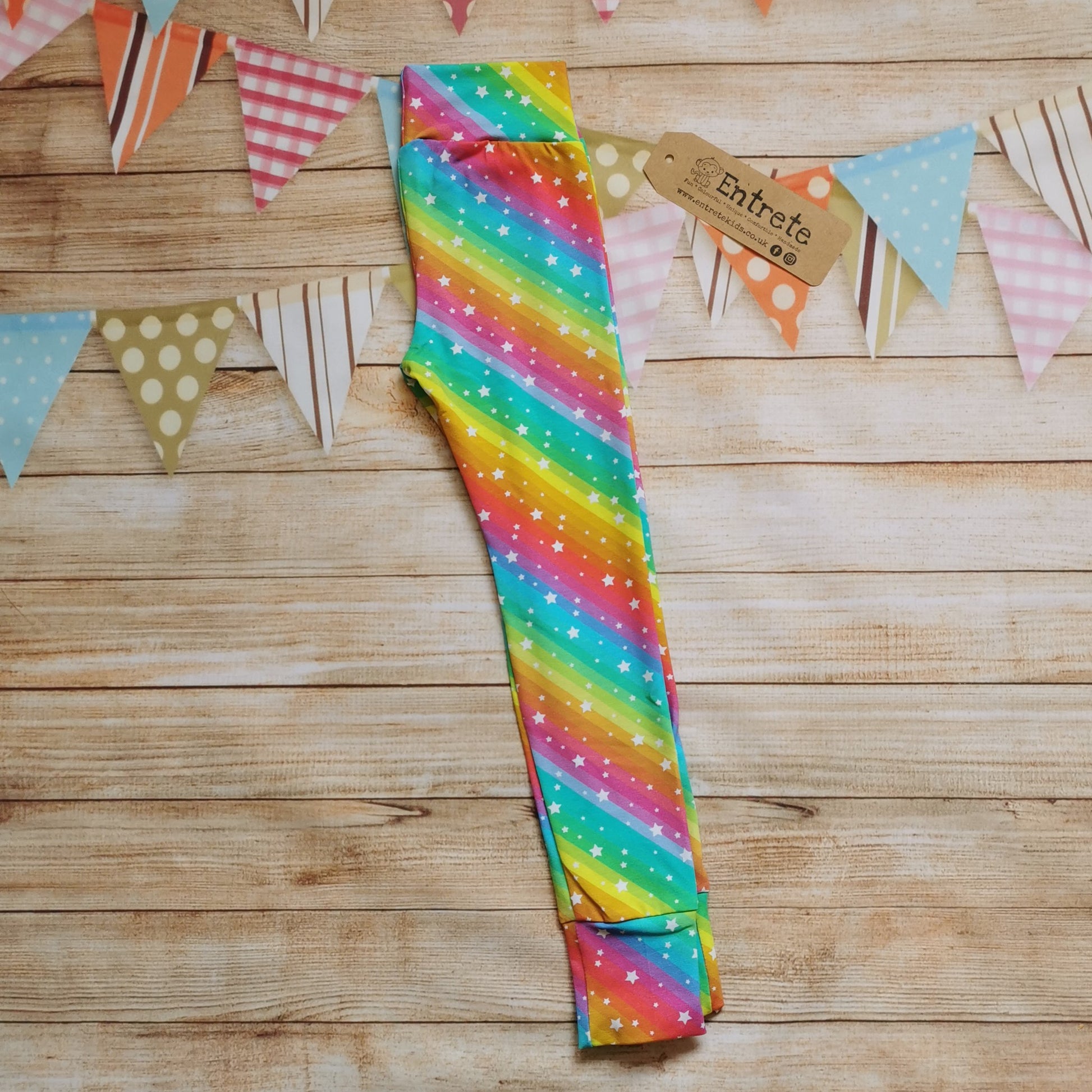 Bright Rainbow Stars Leggings, shown folded.