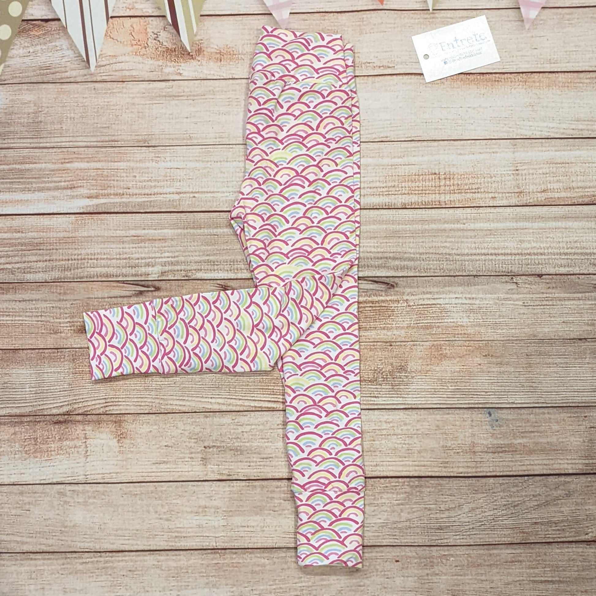 The adorable mini rainbows leggings, handmade using mini rainbows on white cotton jersey. Shown folded. 