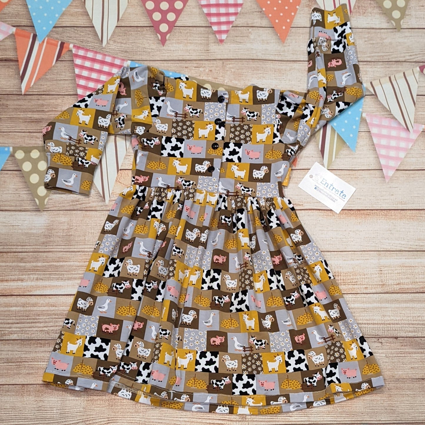 The fun farm animals girls dress. Handmade using checkboard farmyard cotton jersey. Long sleeve model shown from the rear.