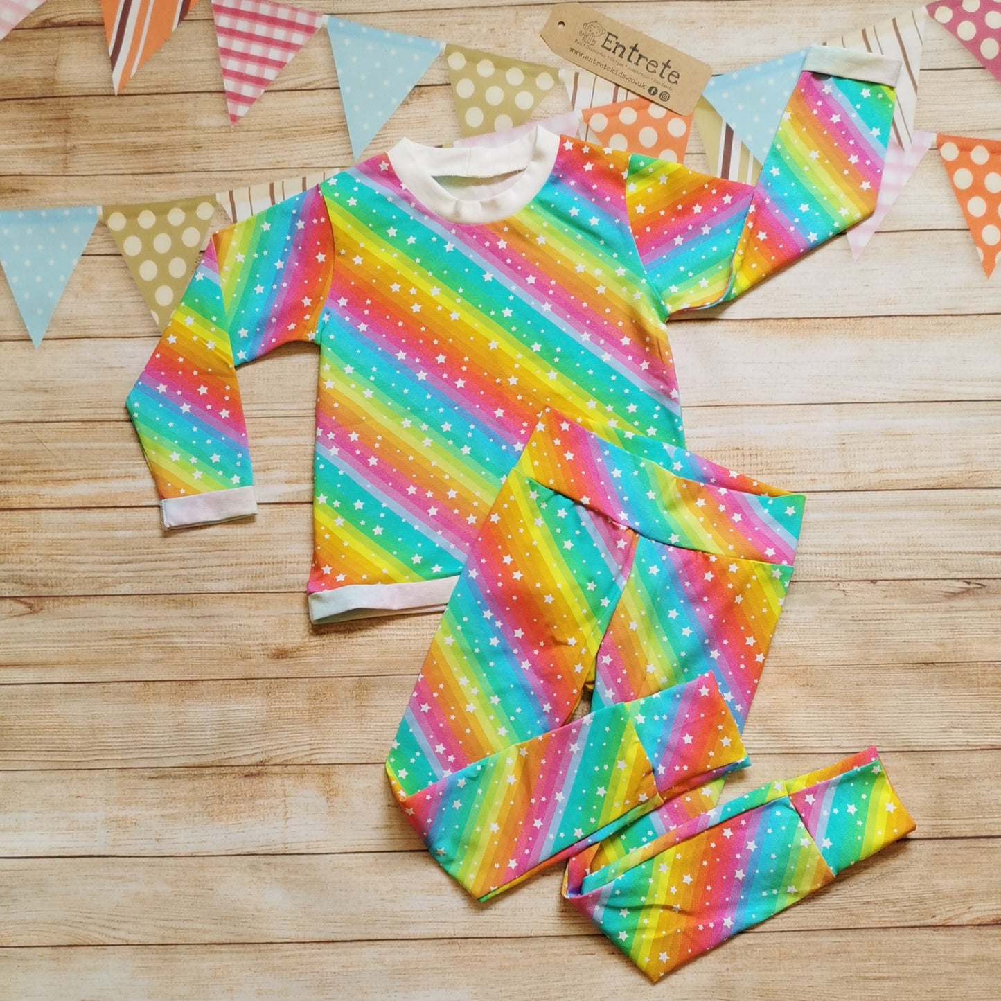 Bright rainbow stars leggings shown as an outfit with matching long sleeved T-shirt. (sold separately).