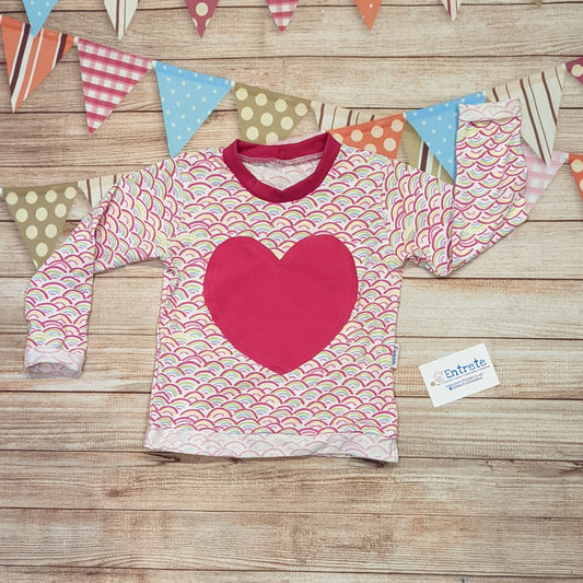 The adorable mini rainbows heart long sleeved T-Shirt. Handmade using mini rainbows on white and fuchsia cotton jersey's, with fuchsia cotton ribbing.