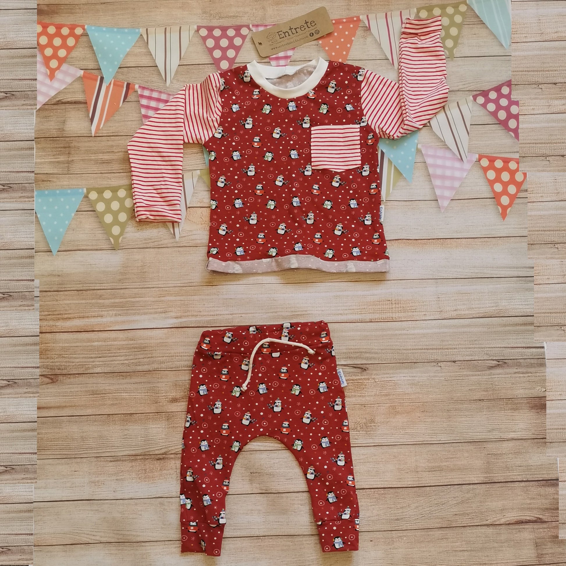 The fun Christmas penguins top shown as a set with matching red penguins harem joggers. (sold separately)