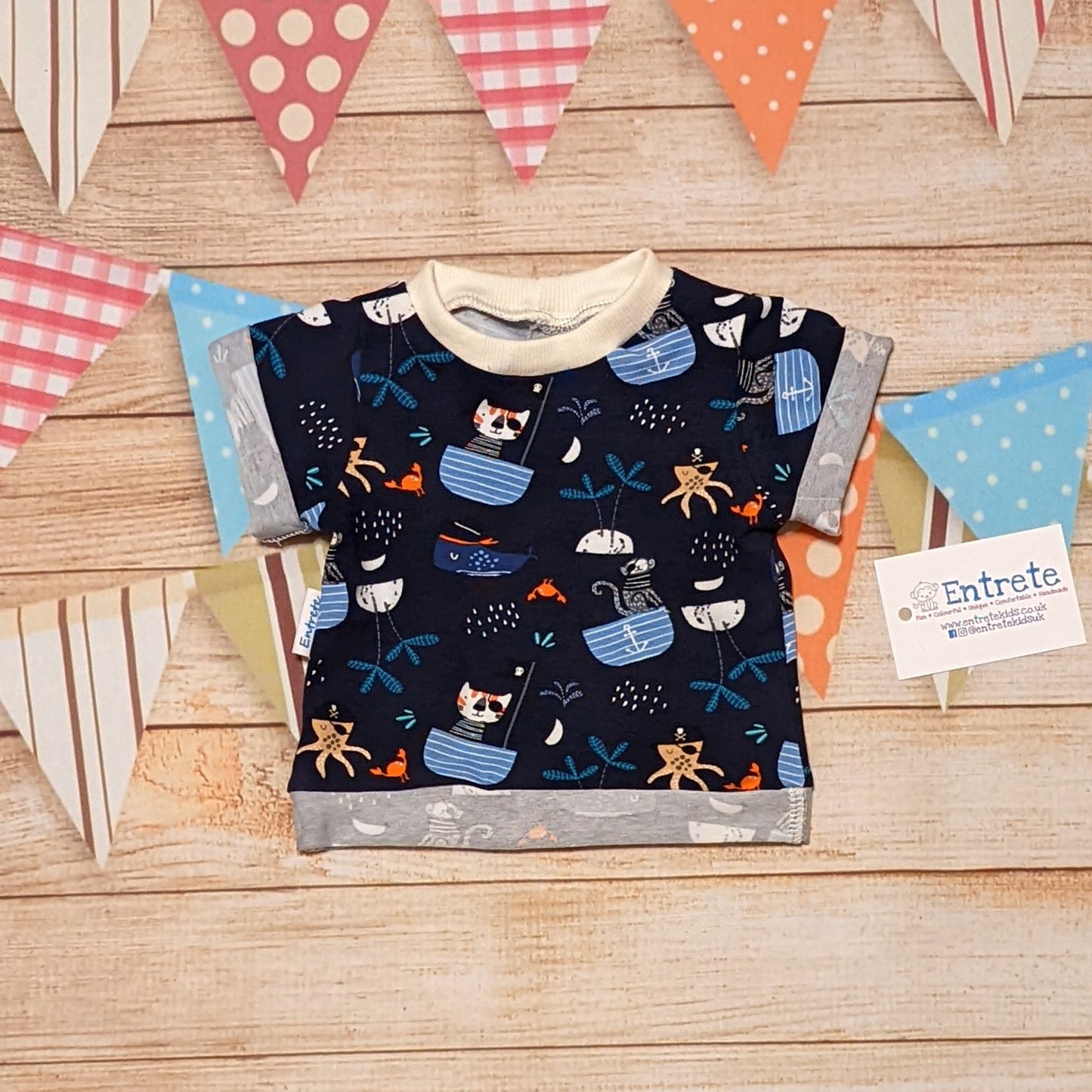 Fun and adventure awaits with the pirate cats T-Shirt. Handmade using pirate cats cotton jersey and cream cotton ribbing.