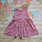 Front of Girls & Babies sleeveless back popper dress, handmade using pretty pink mini hearts cotton jersey.