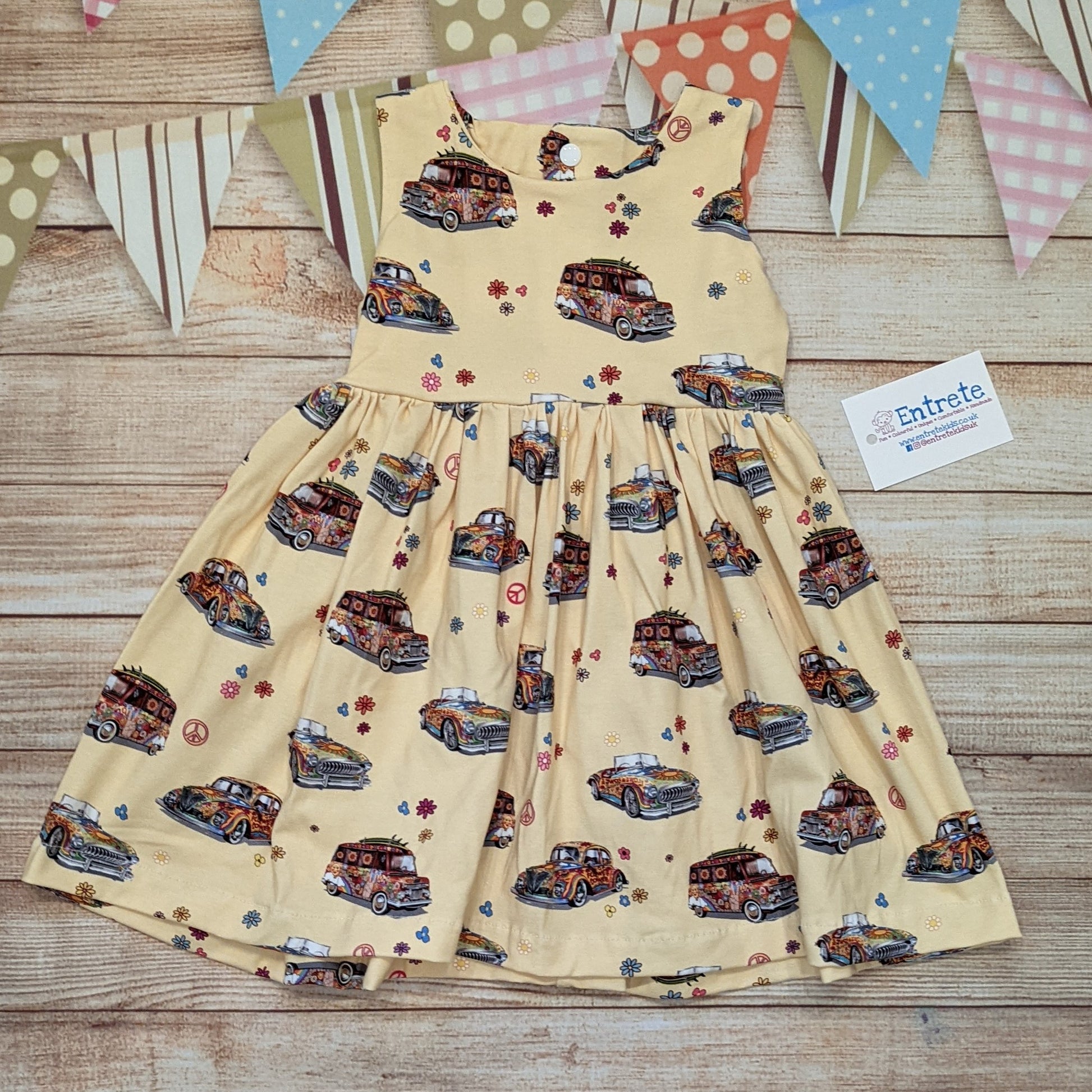 The fun retro hippie cars girls dress, handmade using light yellow hippie cars cotton jersey. Sleeveless model shown.