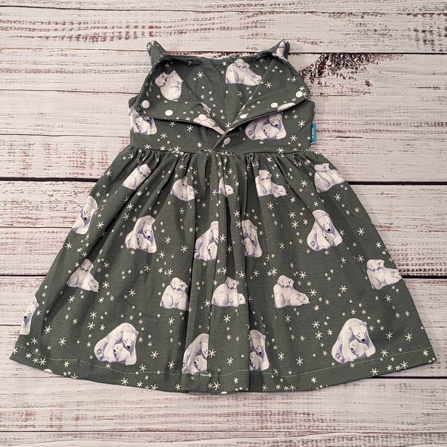 Sleeveless girls Christmas dress, handmade using the gorgeous polar bears cotton jersey. Shown with popper entry open.