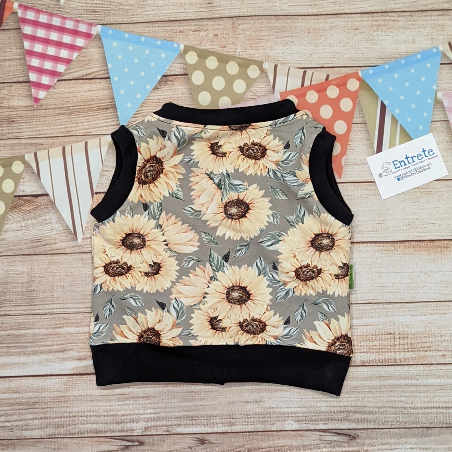 The gorgeous sunflowers sleeveless popper sweatshirt. Handmade using sunflowers cotton French terry, black cotton jersey and black cotton ribbing. Shown from the rear.