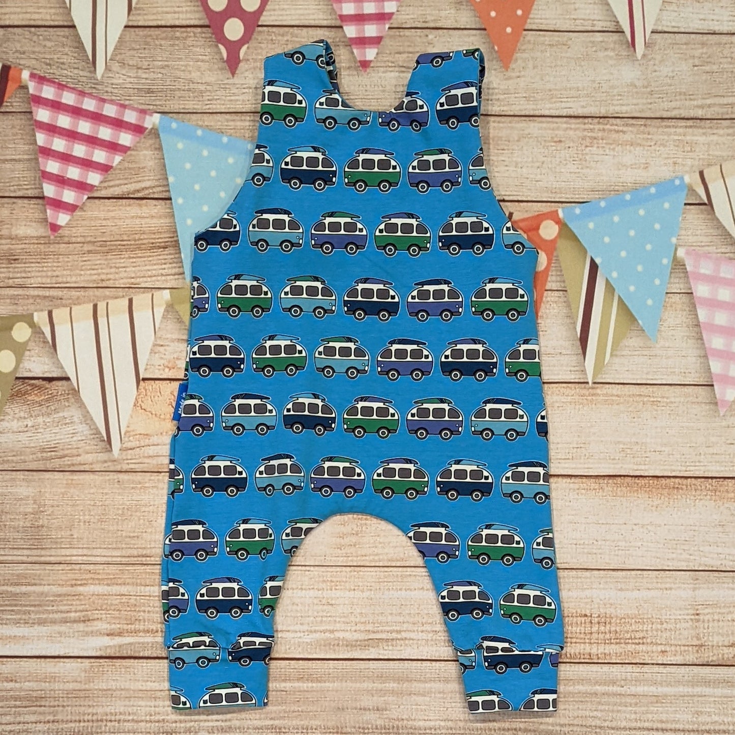 The epic blue surf campervan sleeveless romper. Handmade using blue surf campervan cotton jersey. Shown from the rear.