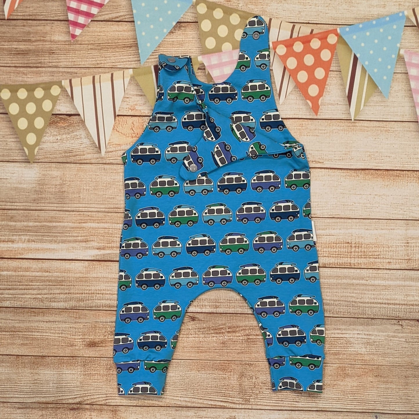 The epic blue surf campervan sleeveless romper. Handmade using blue surf campervan cotton jersey. Shown with one shoulder popper entry open.