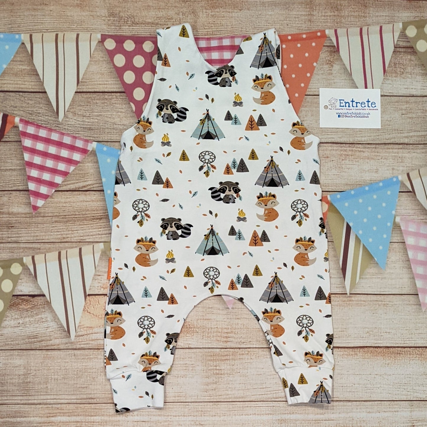 This cute sleeveless romper features a fun foxes and raccoons in a native American camp print. Handmade using native American animals cotton jersey. Shown from the rear.