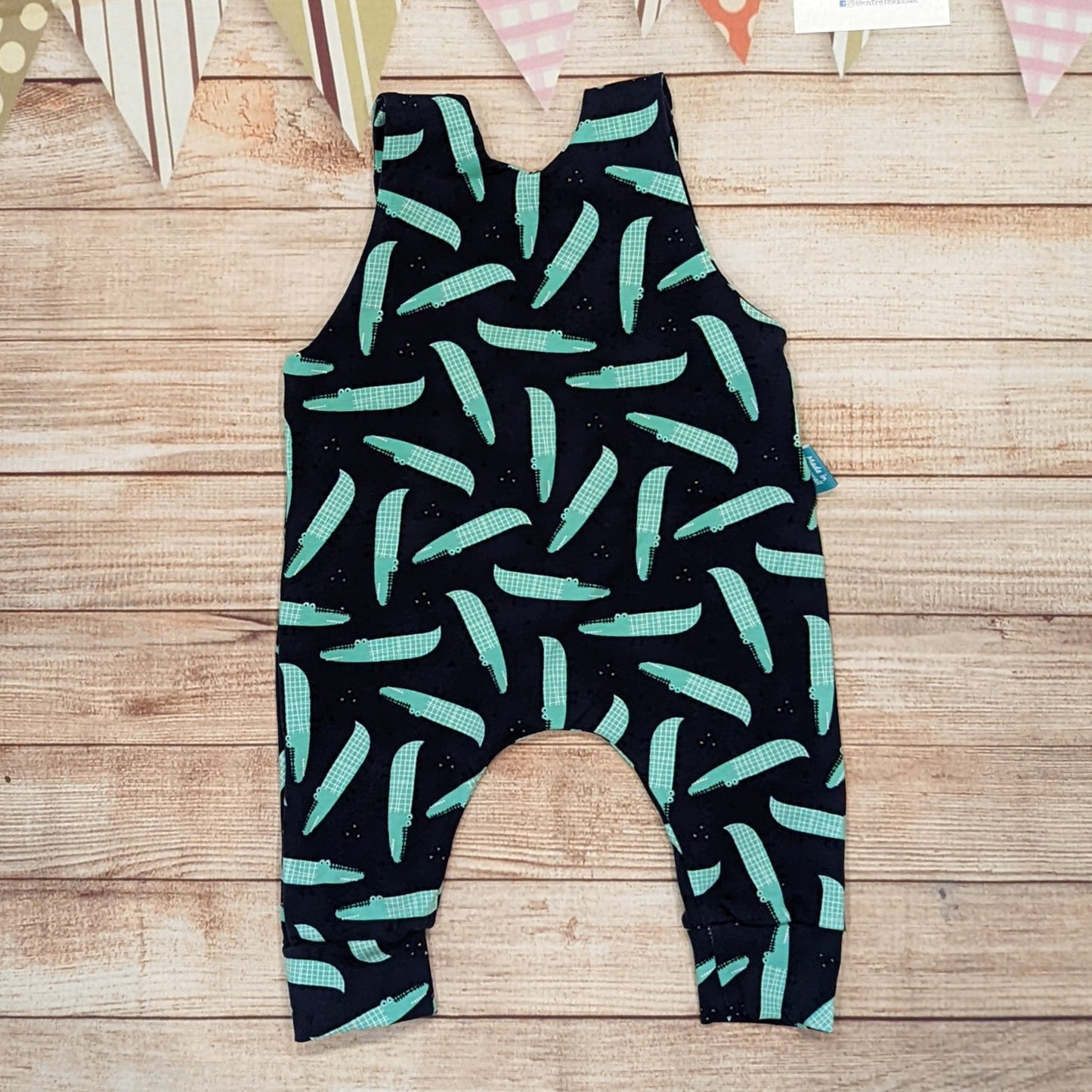 Cool crocodiles sleeveless romper, handmade using navy crocodiles cotton jersey. Shown from the rear.