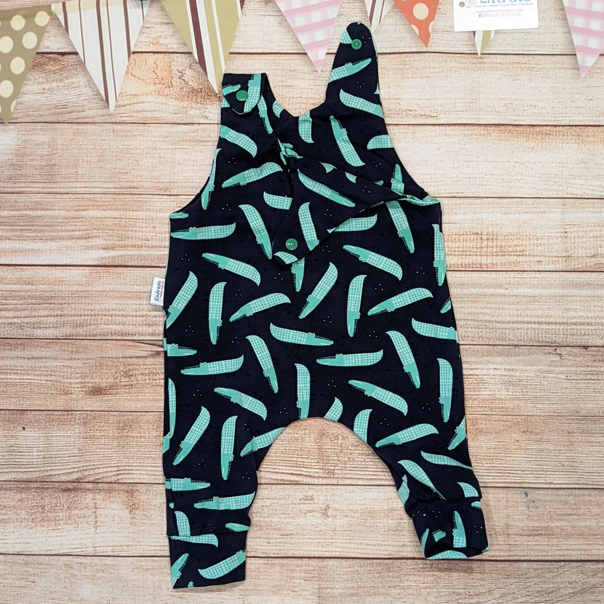 Cool crocodiles sleeveless romper, handmade using navy crocodiles cotton jersey. Shown with one shoulder popper open.