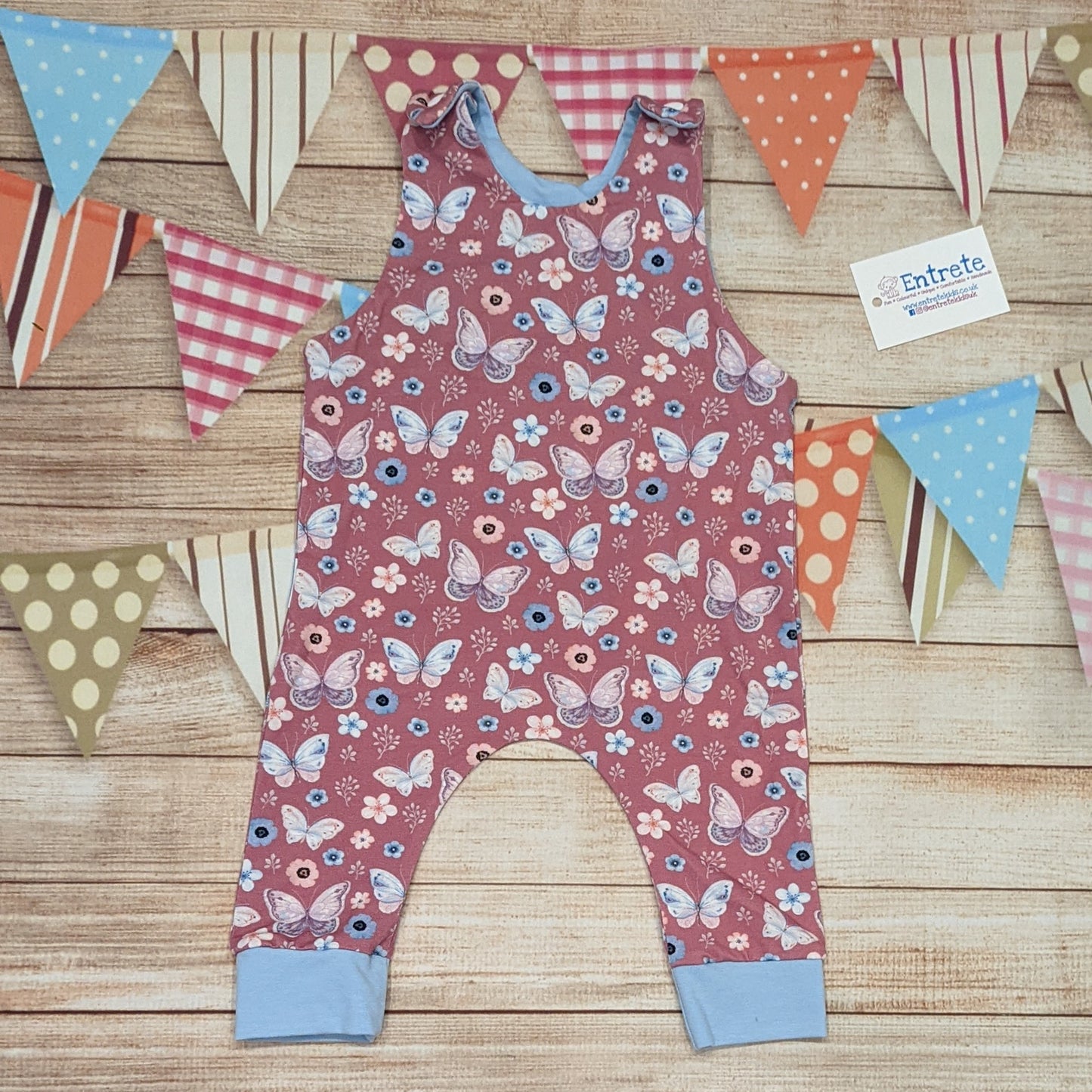 Pretty pink butterflies on contrasting sky blue sleeveless romper. Handmade using organic pink butterflies cotton jersey and sky blue cotton jersey.