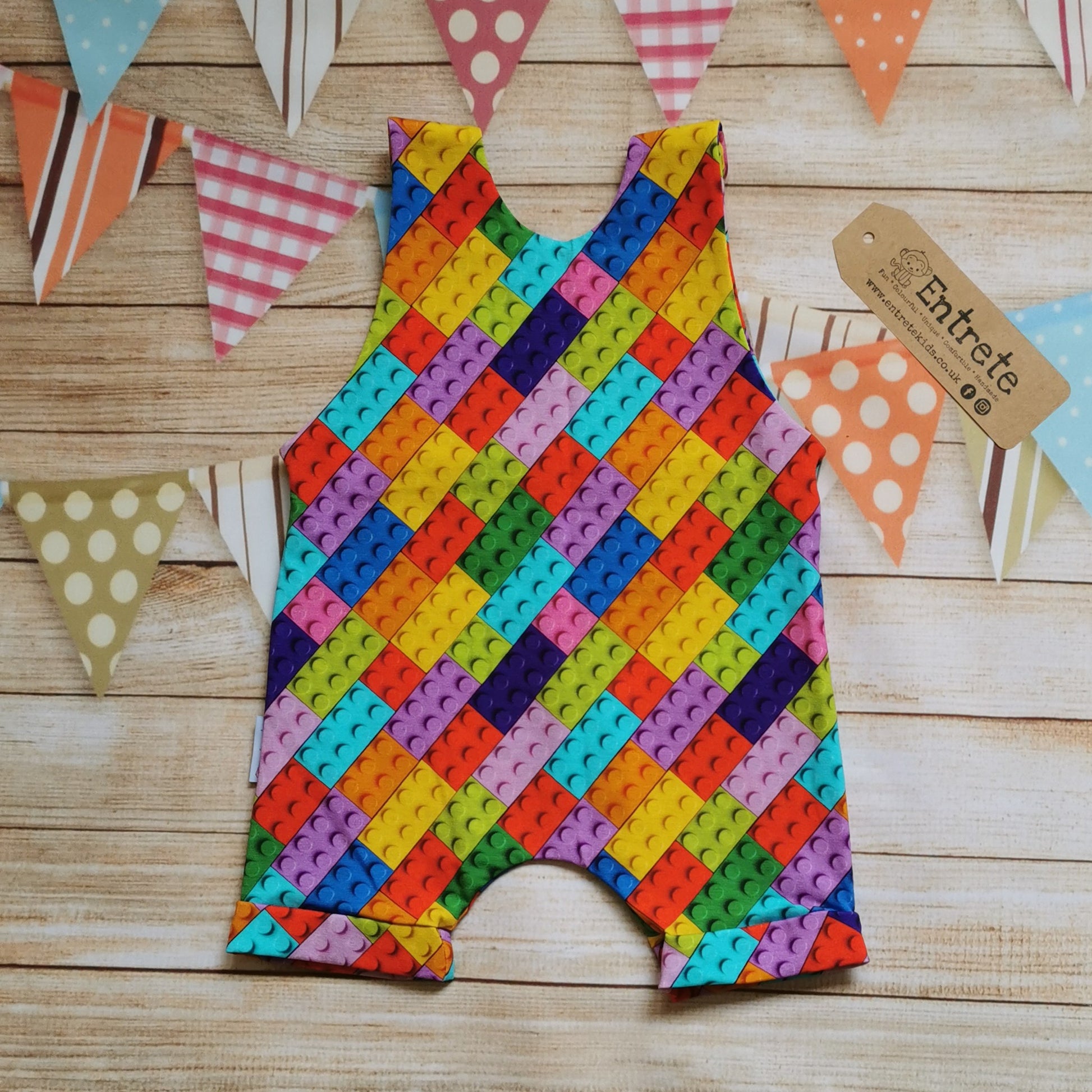 Rear of Unisex Kids sleeveless romper shorts, handmade using colourful building blocks cotton jersey. Perfect for Lego lovers.