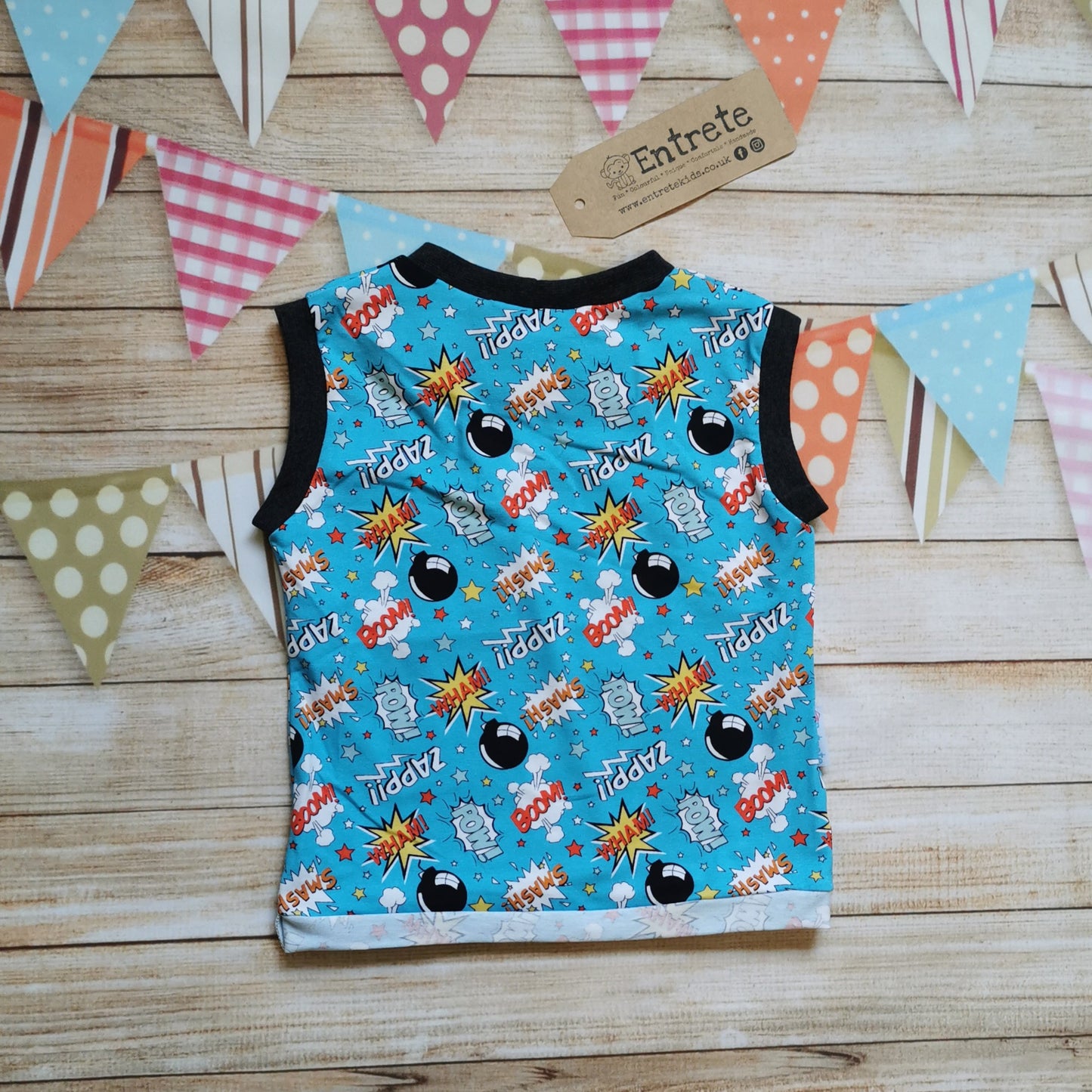 Rear of turquoise cartoon bombs child & Babies vest.