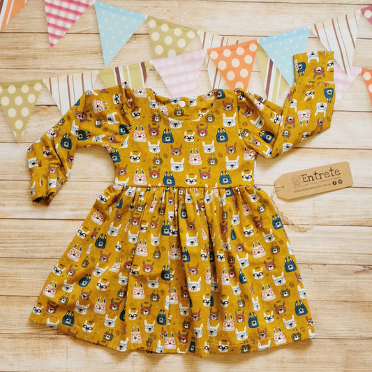 Adorably fun girls and babies back popper dress. Handmade using soft and comfy mustard bunny faces cotton jersey. Shown with long sleeves.