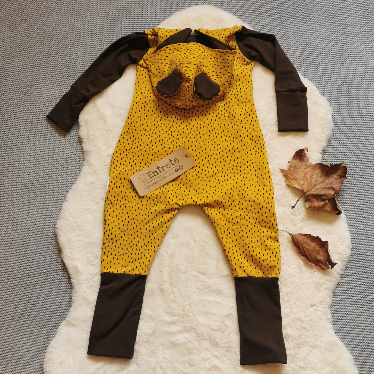 Rear view of The gorgeous and ethical organic lion cub romper. Handmade using ochre dots organic cotton French Terry and brown organic cotton jersey.